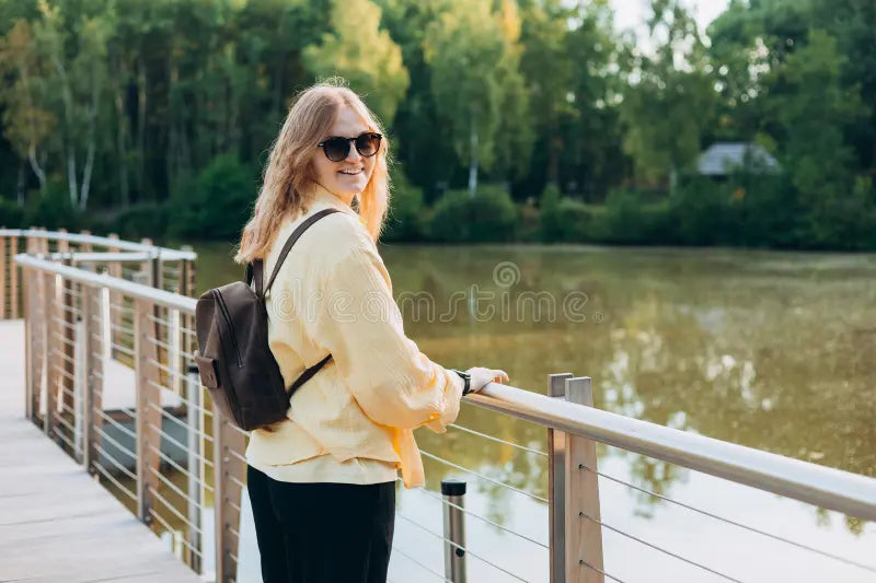 files/young-happy-blonde-woman-standing-bridge-near-lake-sunny-day-beautiful-morning-relax-young-woman-standing-391816710.webp